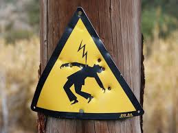 Warning sign with electricity hazard symbol.