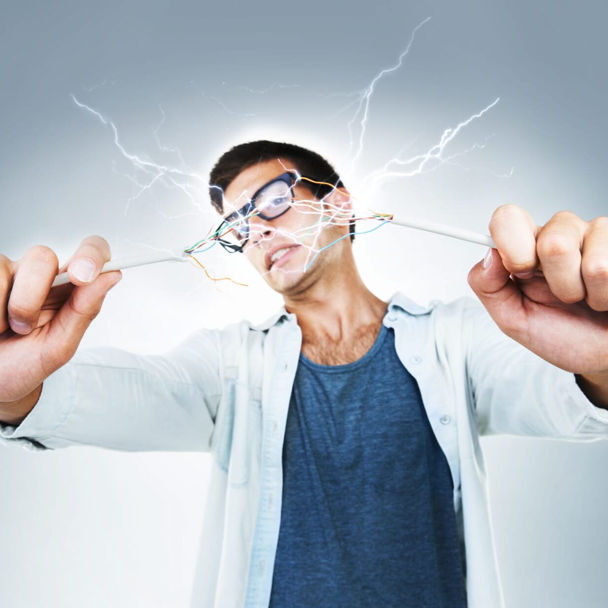 technician holding two live wires