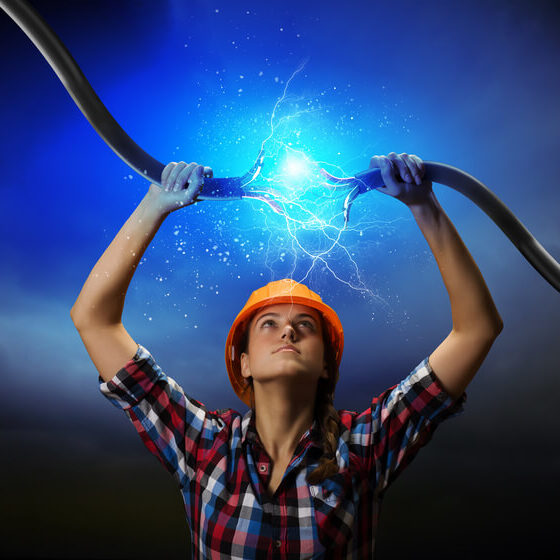 a woman holding electricity cable above head